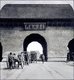 China: Horse-drawn carts entering Beijing's Imperial City through the Da Qing Men or 'Great Qing Gate', also called the Imperial Gate (1901)